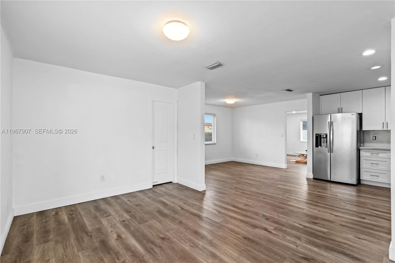 10360 Southwest 24th Street Miami, FL 33165 - Photo 6 of 14 a view of a kitchen with a refrigerator and wooden floor