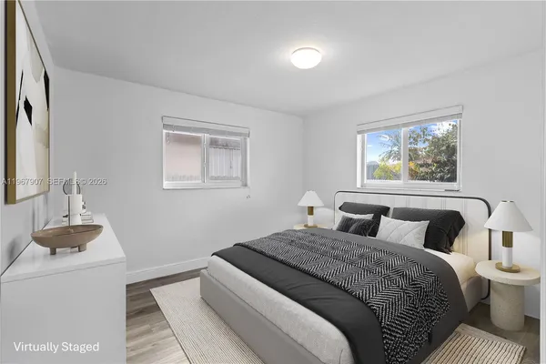 a bedroom with a large bed and a window