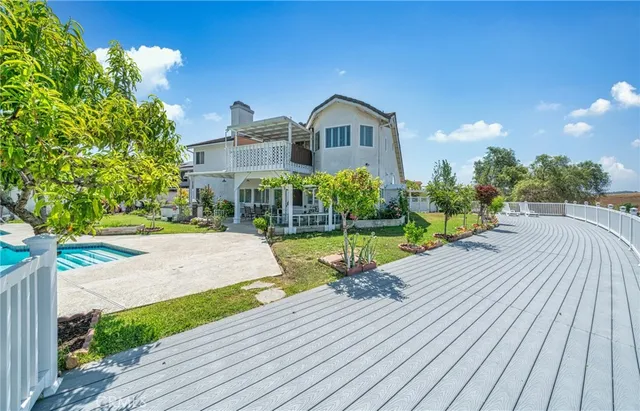 a view of a house with backyard sitting area and garden