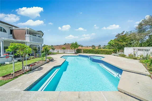a view of house with outdoor space and swimming pool