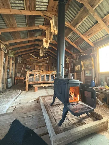 a living room with chairs and a fireplace