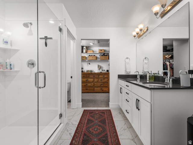 627 South Meade Street Mapleton, UT 84664 - Photo 15 of 48 Double vanity with dark countertops and a full-width mirror