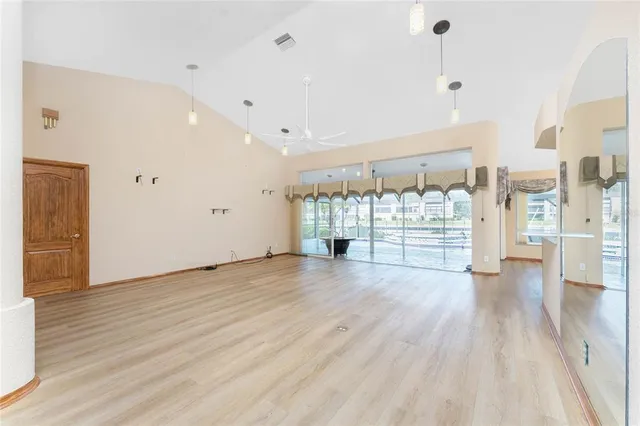 a kitchen with stainless steel appliances granite countertop a sink a stove cabinets and living room view