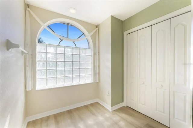 a view of empty room with wooden floor