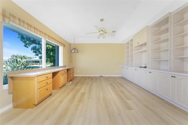 a view of a swimming pool with a couches chairs under an umbrella