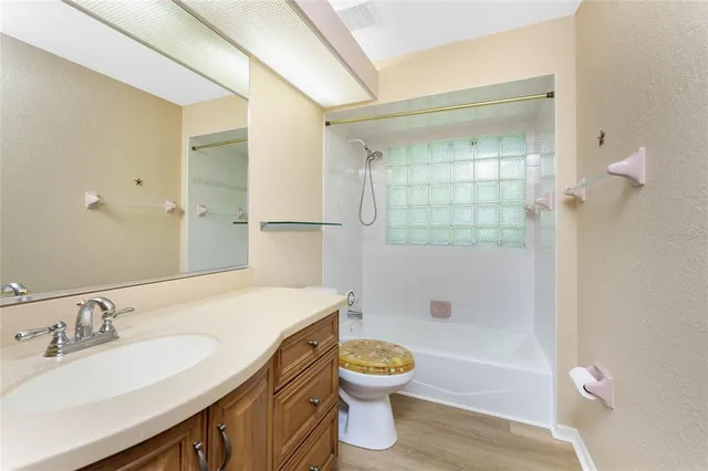 a view of a house with a yard and potted plants