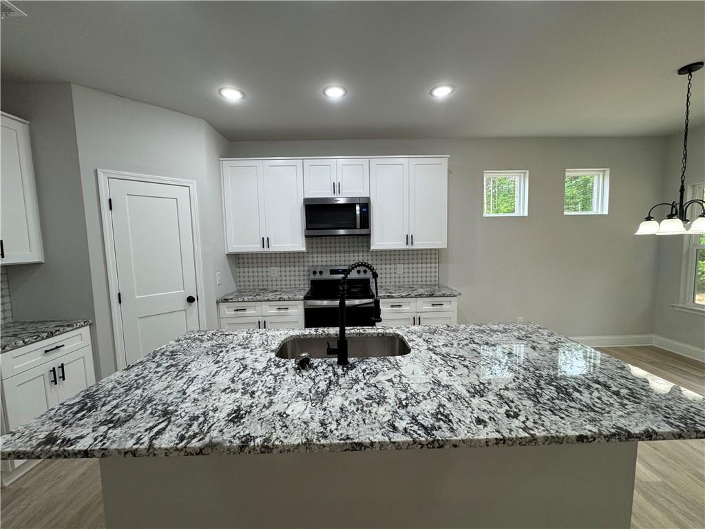 2057 North Hicks Road Toccoa, GA 30577 - Photo 11 of 23 a kitchen with a sink stove and refrigerator