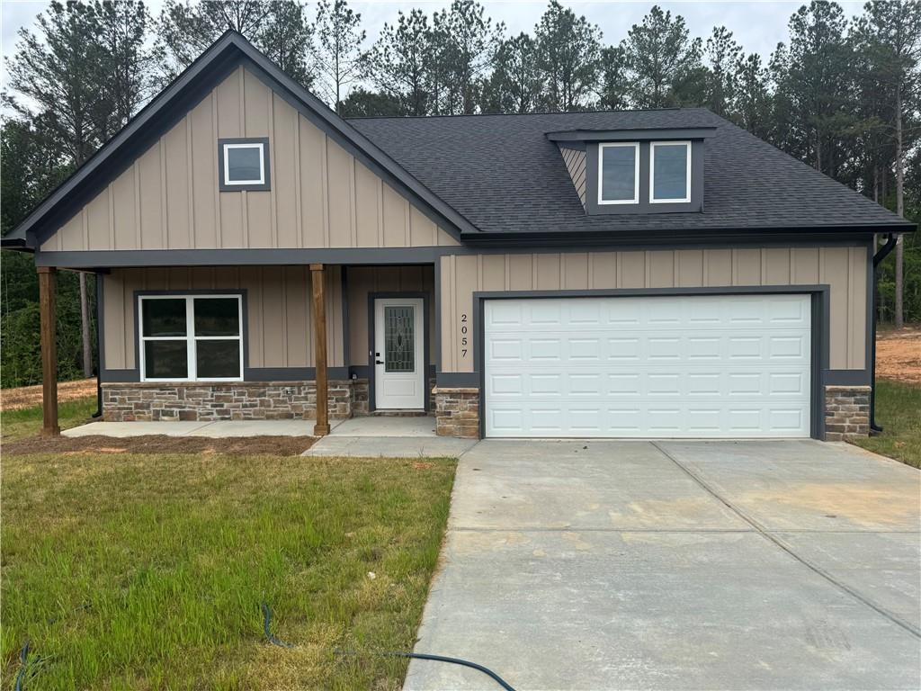 2057 North Hicks Road Toccoa, GA 30577 - Photo 2 of 23 a front view of a house with a yard and garage