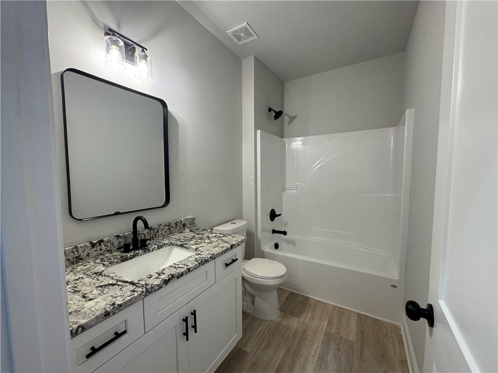 2057 North Hicks Road Toccoa, GA 30577 - Photo 5 of 23 a bathroom with a granite countertop sink toilet and shower