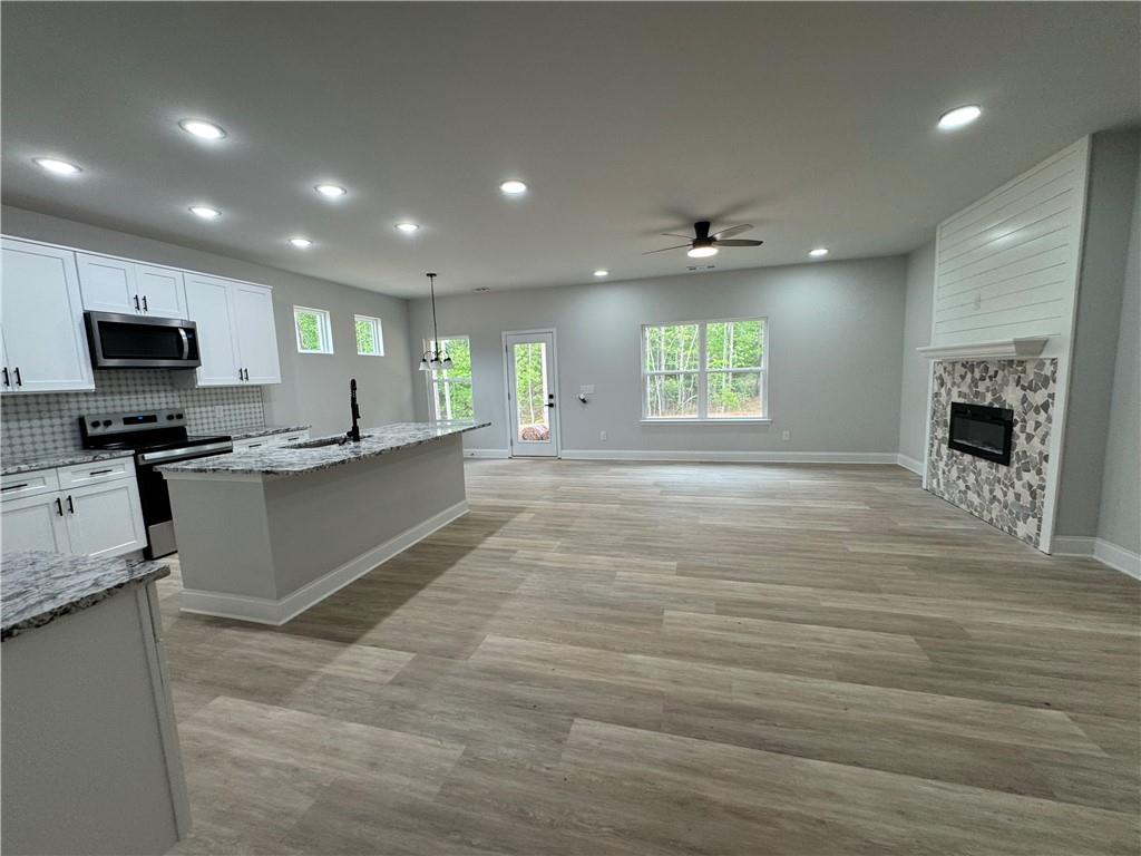 2057 North Hicks Road Toccoa, GA 30577 - Photo 8 of 23 a large kitchen with stainless steel appliances granite countertop a large counter top a stove a sink and a refrigerator