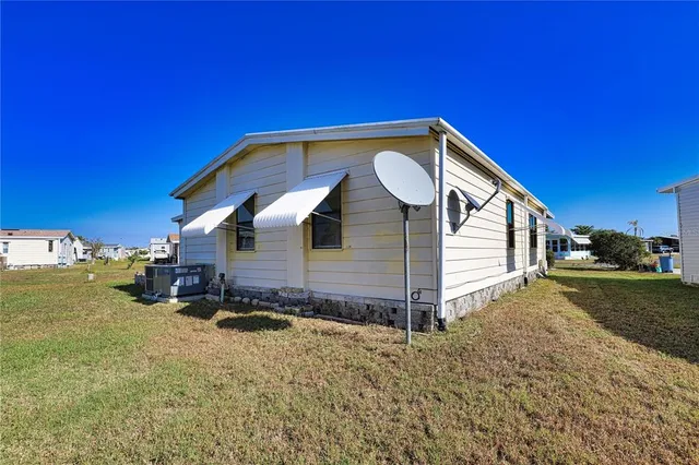 a view of a house with swimming pool and a yard