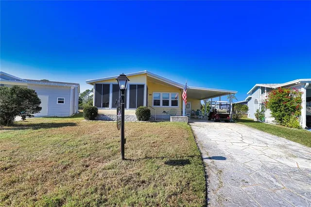 a living room with lots of furniture and a large window