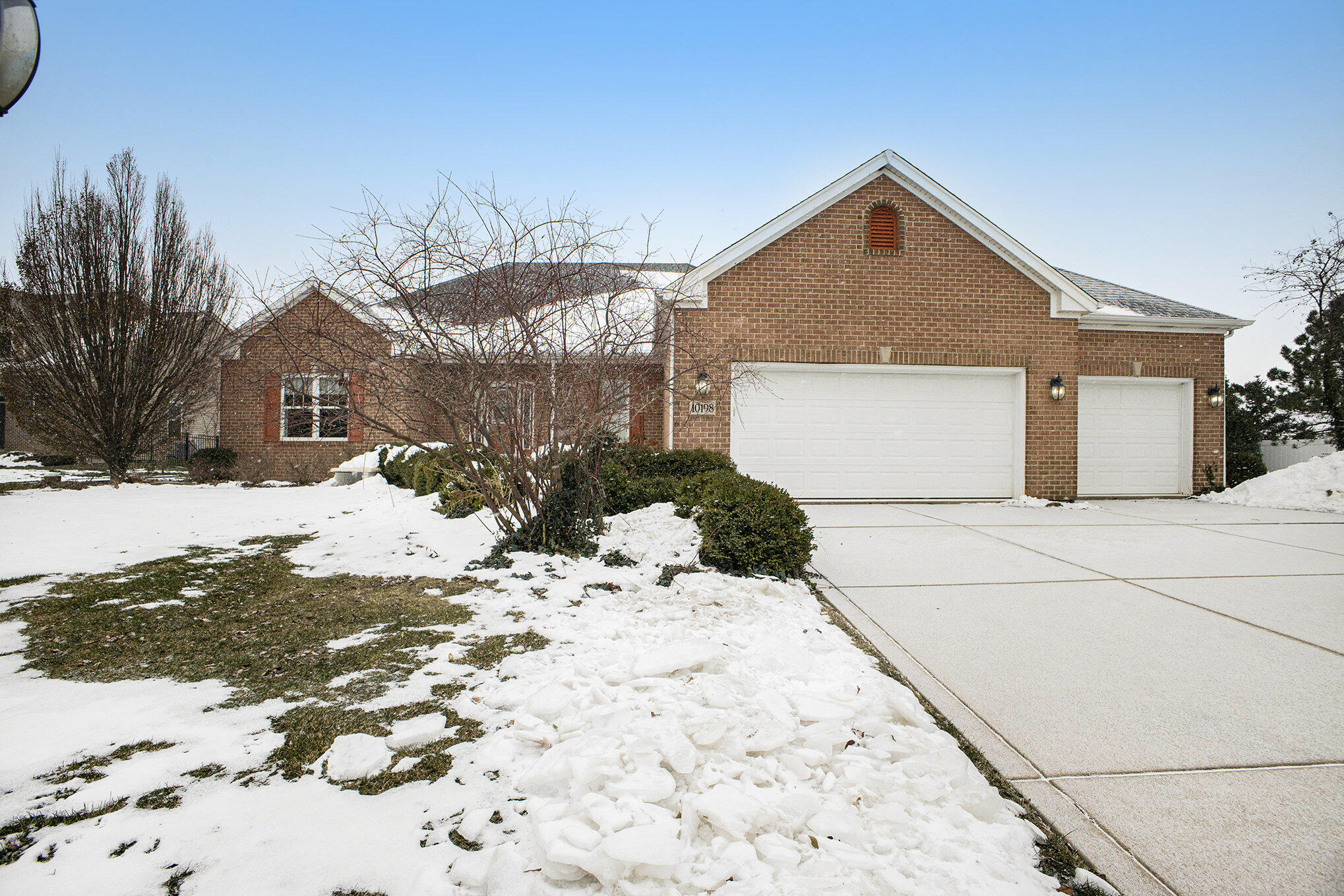 10198 California Street Crown Point, IN 46307 - Photo 2 of 41 a view of a house with a yard covered in snow