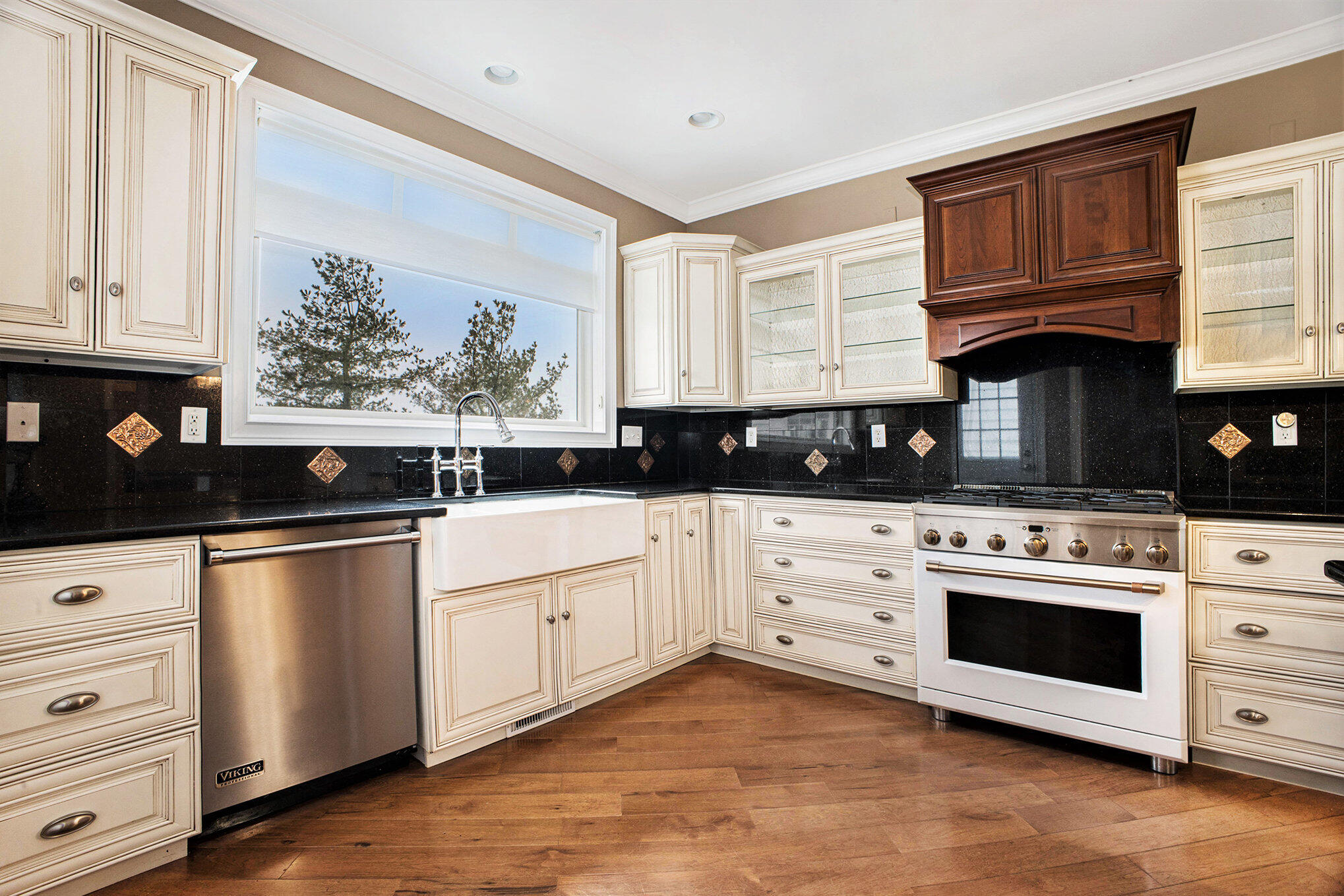10198 California Street Crown Point, IN 46307 - Photo 7 of 41 a kitchen with stainless steel appliances granite countertop a stove a sink and white cabinets