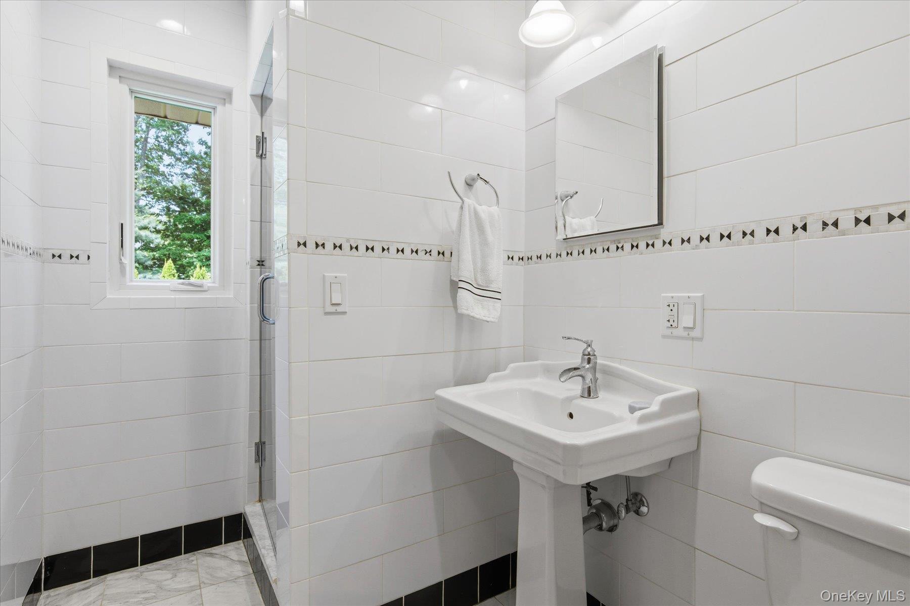 42 Cliff Road Port Jefferson, NY 11777 - Photo 14 of 22 a bathroom with a sink a toilet and shower