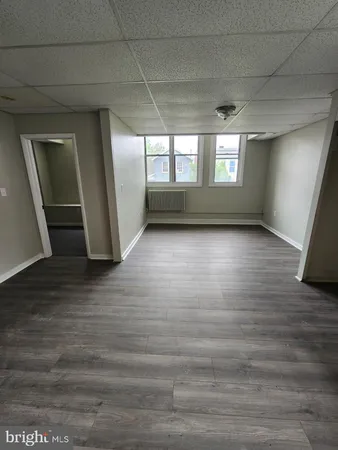 a view of wooden floor and windows in an empty room