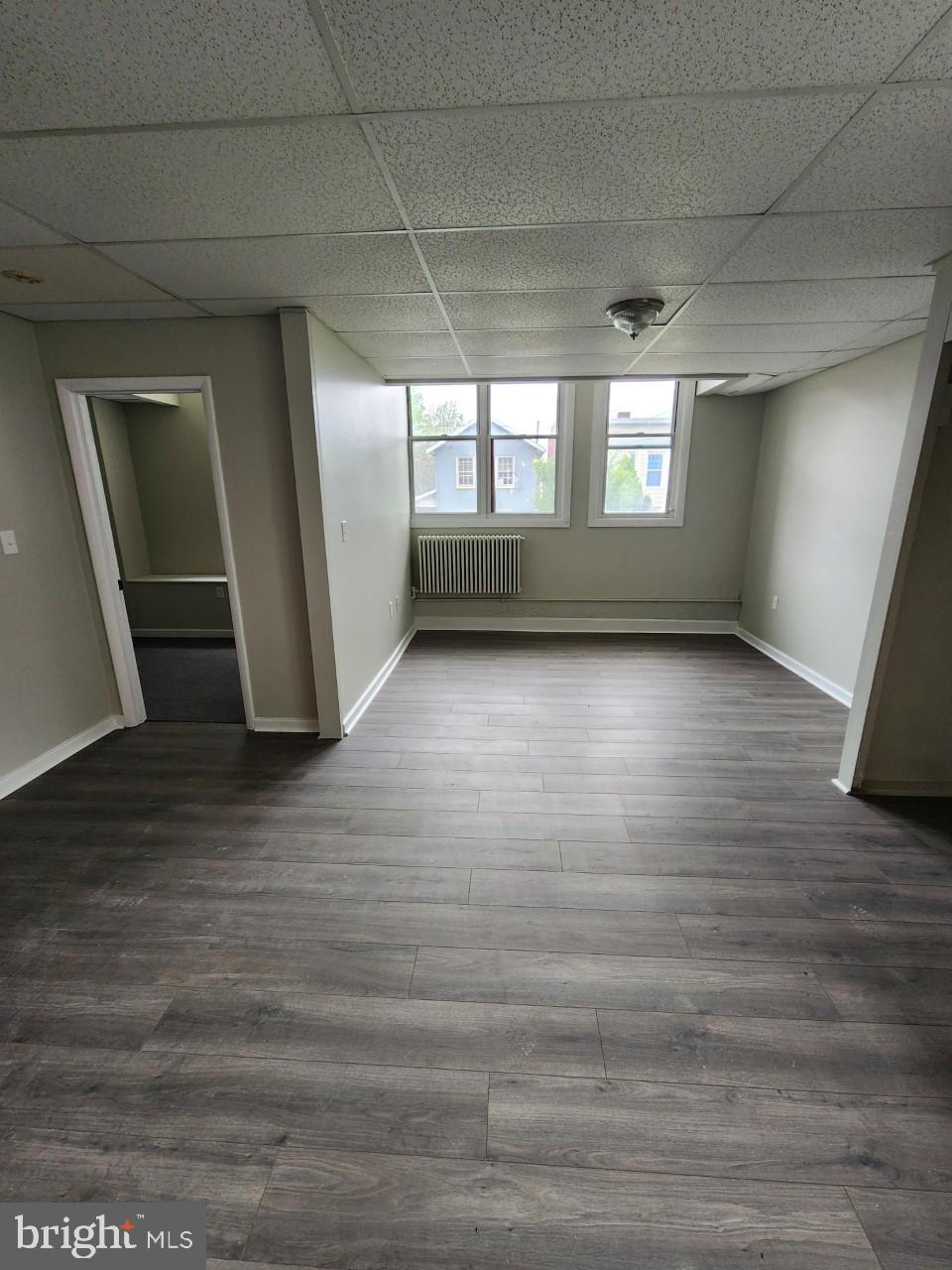 311 Columbia Street, Unit 8 Cumberland, MD 21502 - Photo 5 of 13 a view of wooden floor and windows in an empty room