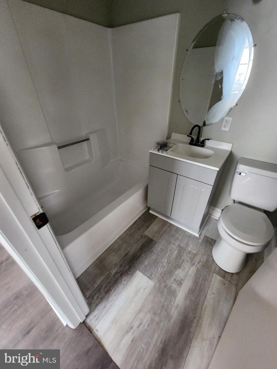 311 Columbia Street, Unit 8 Cumberland, MD 21502 - Photo 6 of 13 a bathroom with a toilet and a mirror