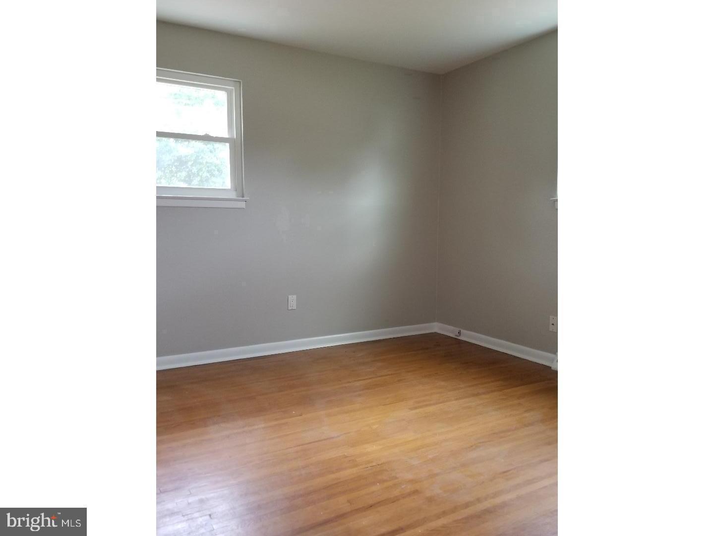 229 Deptford Road Glassboro, NJ 08028 - Photo 6 of 7 a view of an empty room with wooden floor and a window