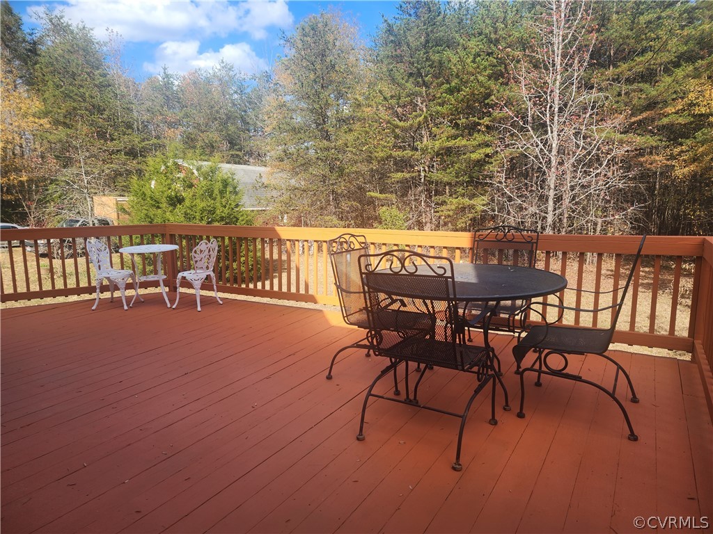 20802 Beaver Dam Road Beaverdam, VA 23015 - Photo 35 of 49 a view of a patio with table and chairs with wooden floor and fence