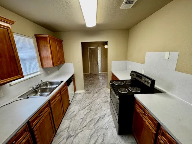 a kitchen with a stove and a refrigerator