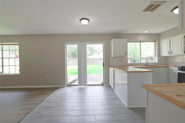 a view of a kitchen with a sink and windows