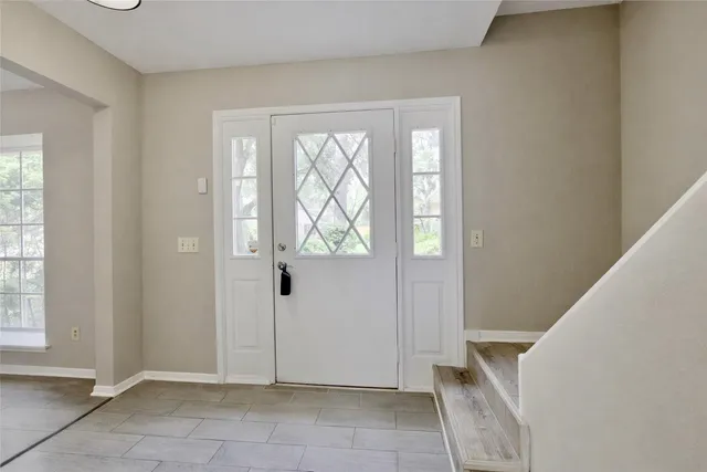 a view of an entryway with wooden floor