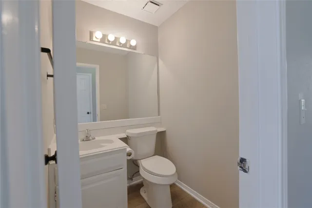 a bathroom with a toilet a sink and mirror
