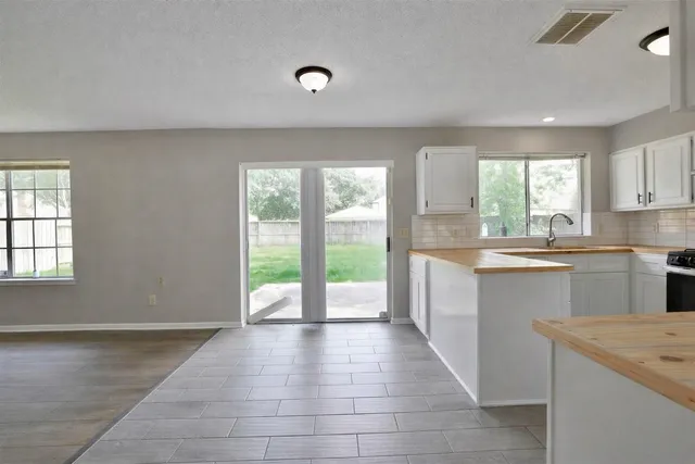 a kitchen with a sink a counter top space and cabinets