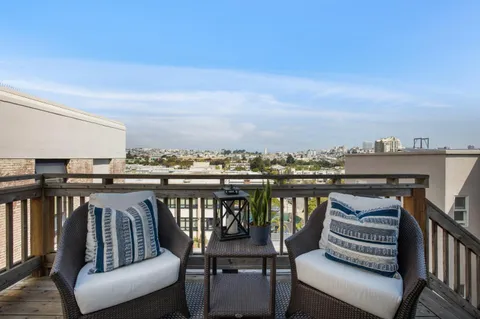 a view of a roof deck with furniture