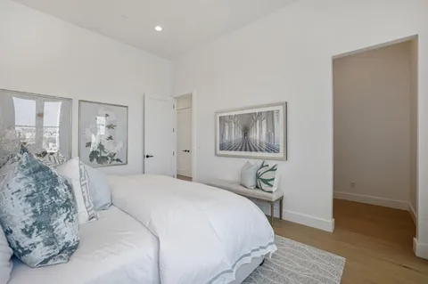 a bedroom with a large bed and a chandelier