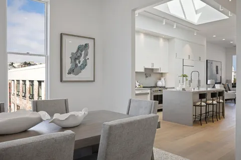a living room with furniture and kitchen view