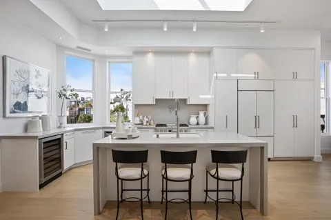 a kitchen with a sink cabinets and window