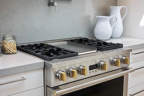a stove top oven sitting inside of a kitchen