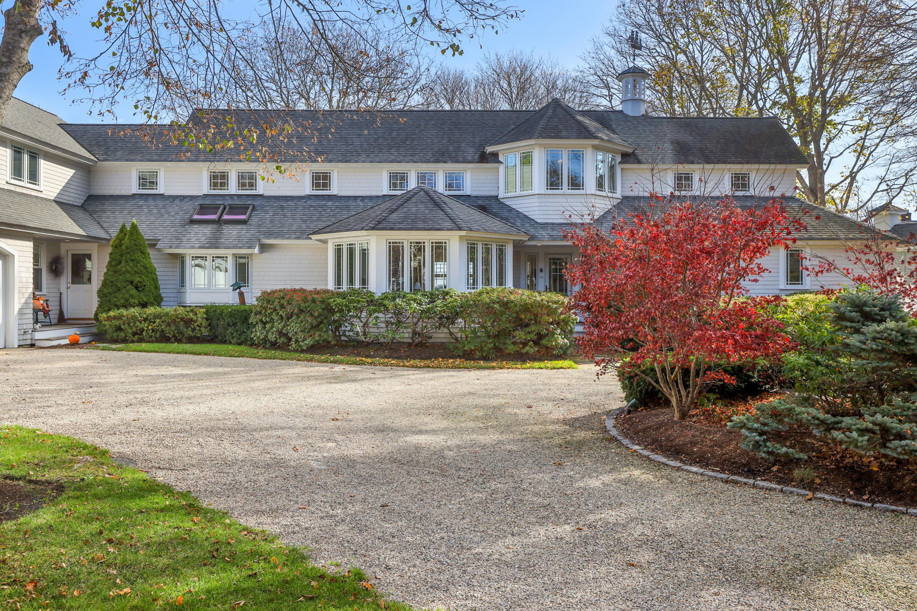 108 Little River Road Cotuit, MA 02635 - Photo 42 of 59 a front view of a house with a yard and a garage
