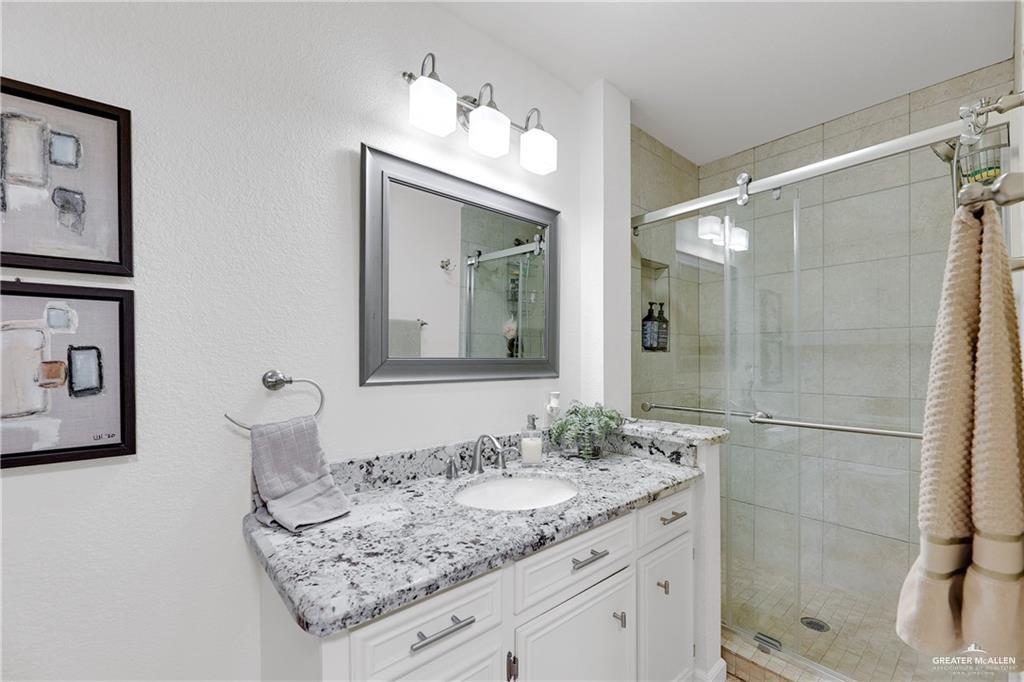 2036 South 5th Street, Unit 8 McAllen, TX 78503 - Photo 13 of 27 a bathroom with a granite countertop sink and a mirror