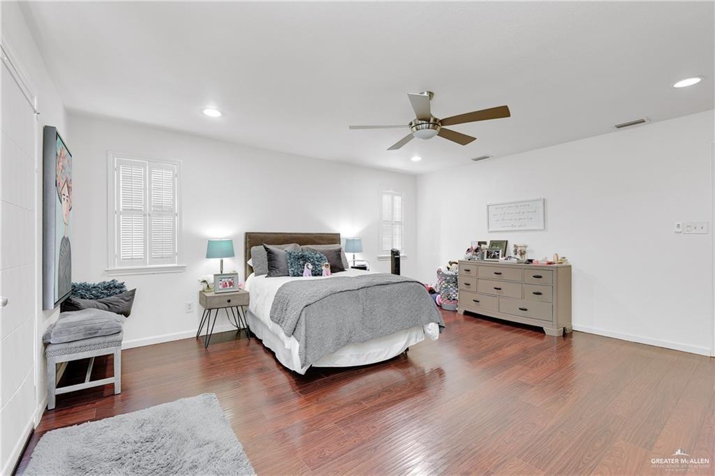 2036 South 5th Street, Unit 8 McAllen, TX 78503 - Photo 14 of 27 a bedroom with a bed and a chandelier