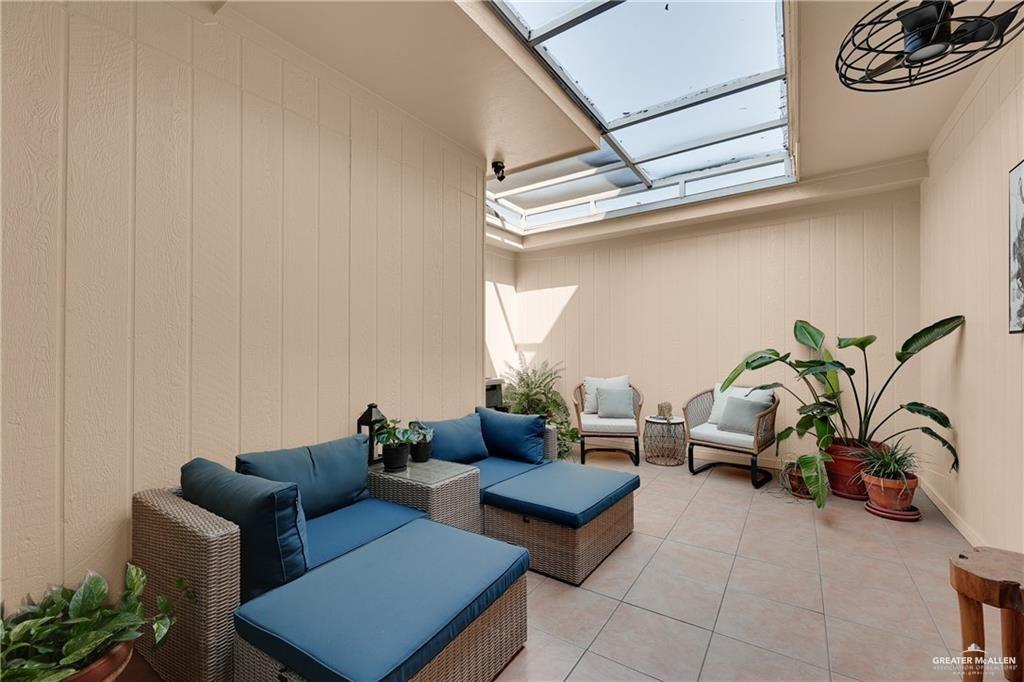 2036 South 5th Street, Unit 8 McAllen, TX 78503 - Photo 23 of 27 a living room with furniture and a potted plant
