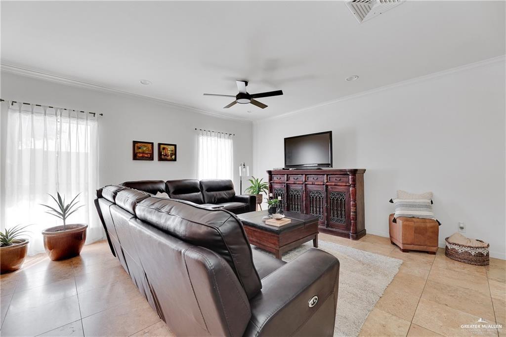2036 South 5th Street, Unit 8 McAllen, TX 78503 - Photo 4 of 27 a living room with furniture and a chandelier