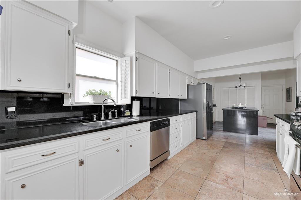 2036 South 5th Street, Unit 8 McAllen, TX 78503 - Photo 7 of 27 a large kitchen with stainless steel appliances granite countertop a sink and cabinets