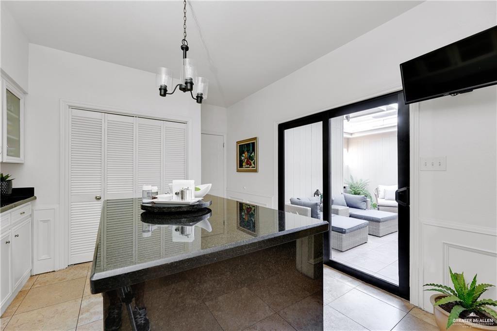 2036 South 5th Street, Unit 8 McAllen, TX 78503 - Photo 10 of 27 a dining room with furniture and wooden floor