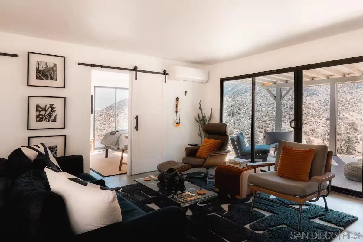 48311 Burns Canyon Road Pioneertown, CA 92268 - Photo 12 of 52 a living room with furniture and large windows