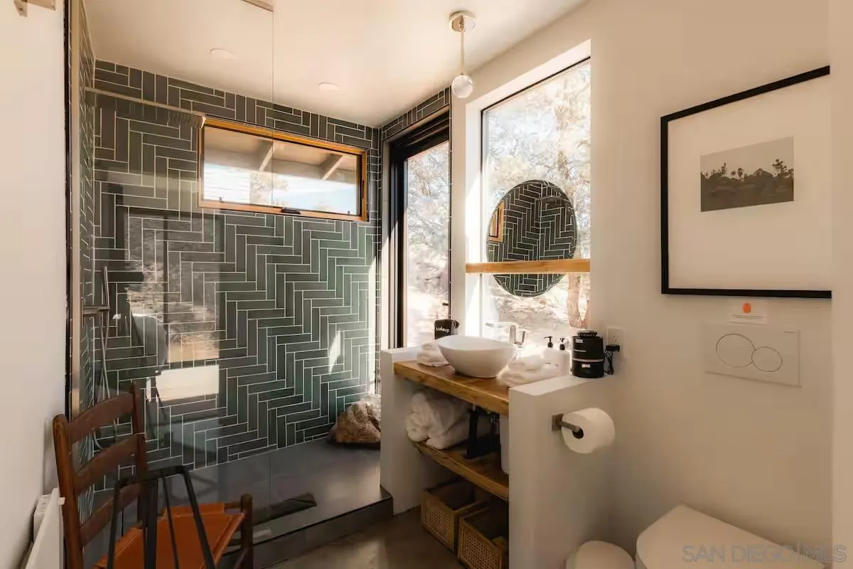 48311 Burns Canyon Road Pioneertown, CA 92268 - Photo 27 of 52 a bathroom with a toilet sink and mirror
