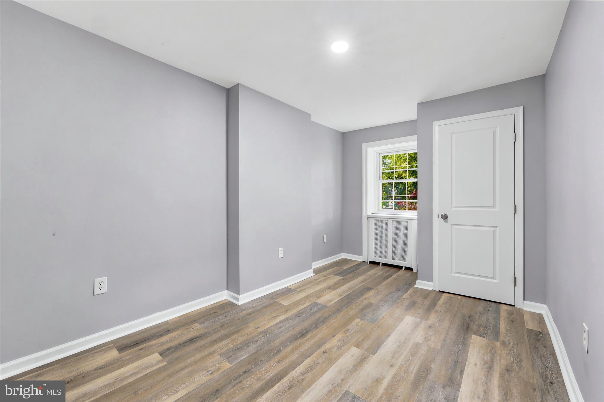 7208 Hilltop Road Upper Darby, PA 19082 - Photo 20 of 28 an empty room with wooden floor and windows