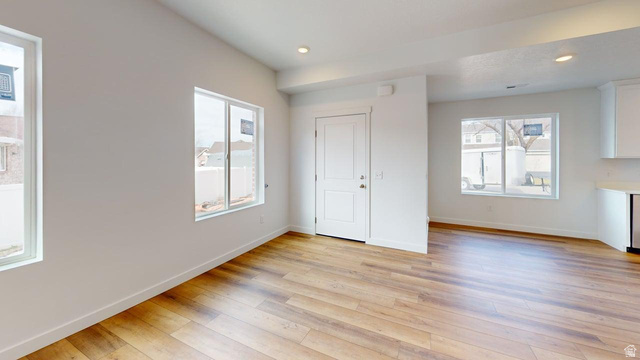 783 Pheasantbrook Drive, Unit 2A Centerville, UT 84014 - Photo 7 of 41 Open-concept living space with wood-finish flooring, recessed lighting, white walls, and multiple windows
