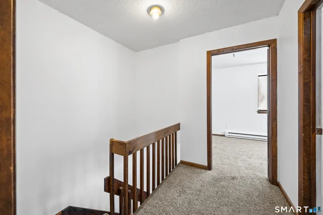 a view of a hallway with seating area
