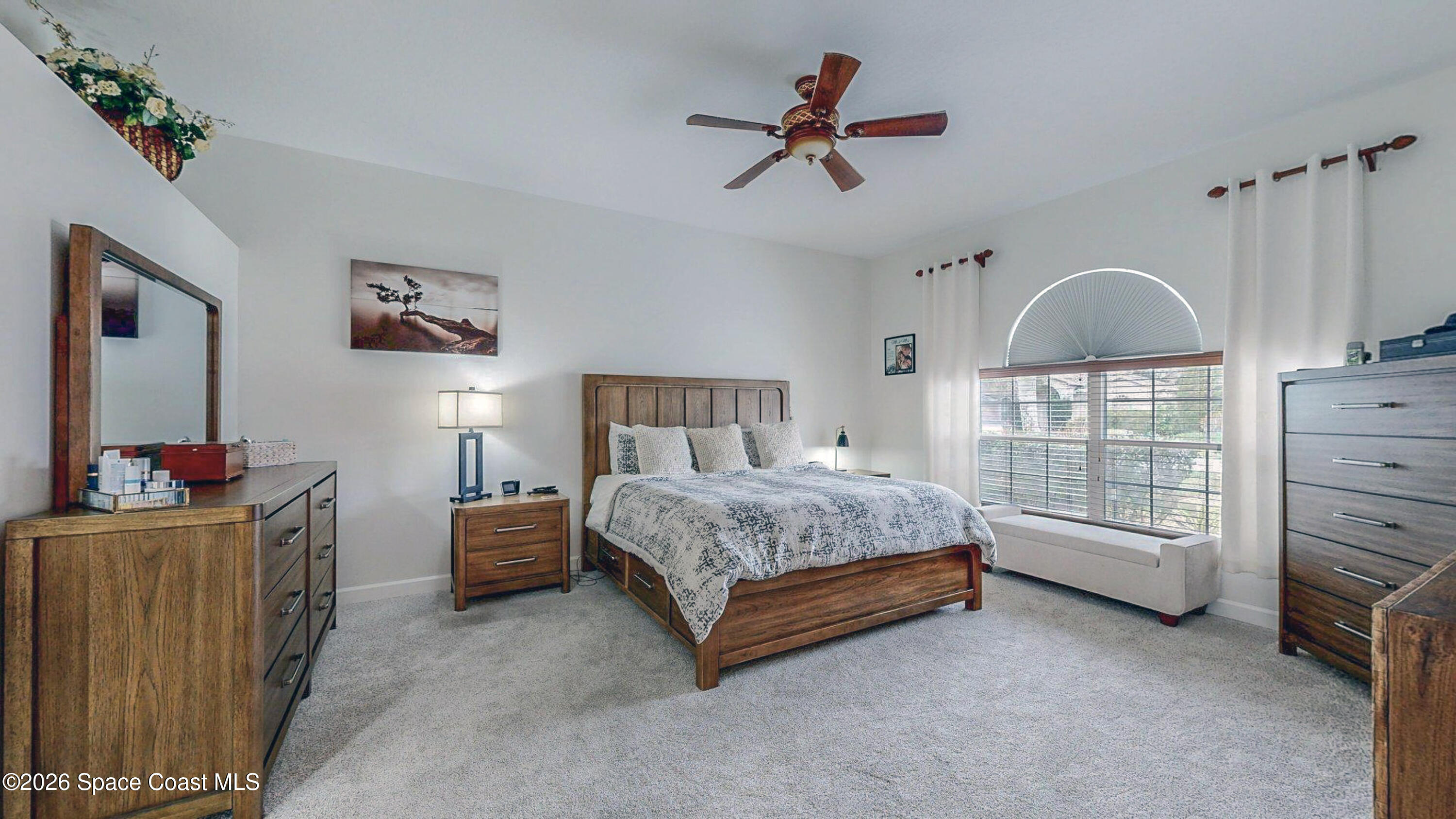 786 Conestee Drive Melbourne, FL 32904 - Photo 12 of 38 a bedroom with a bed a dresser and next to a window