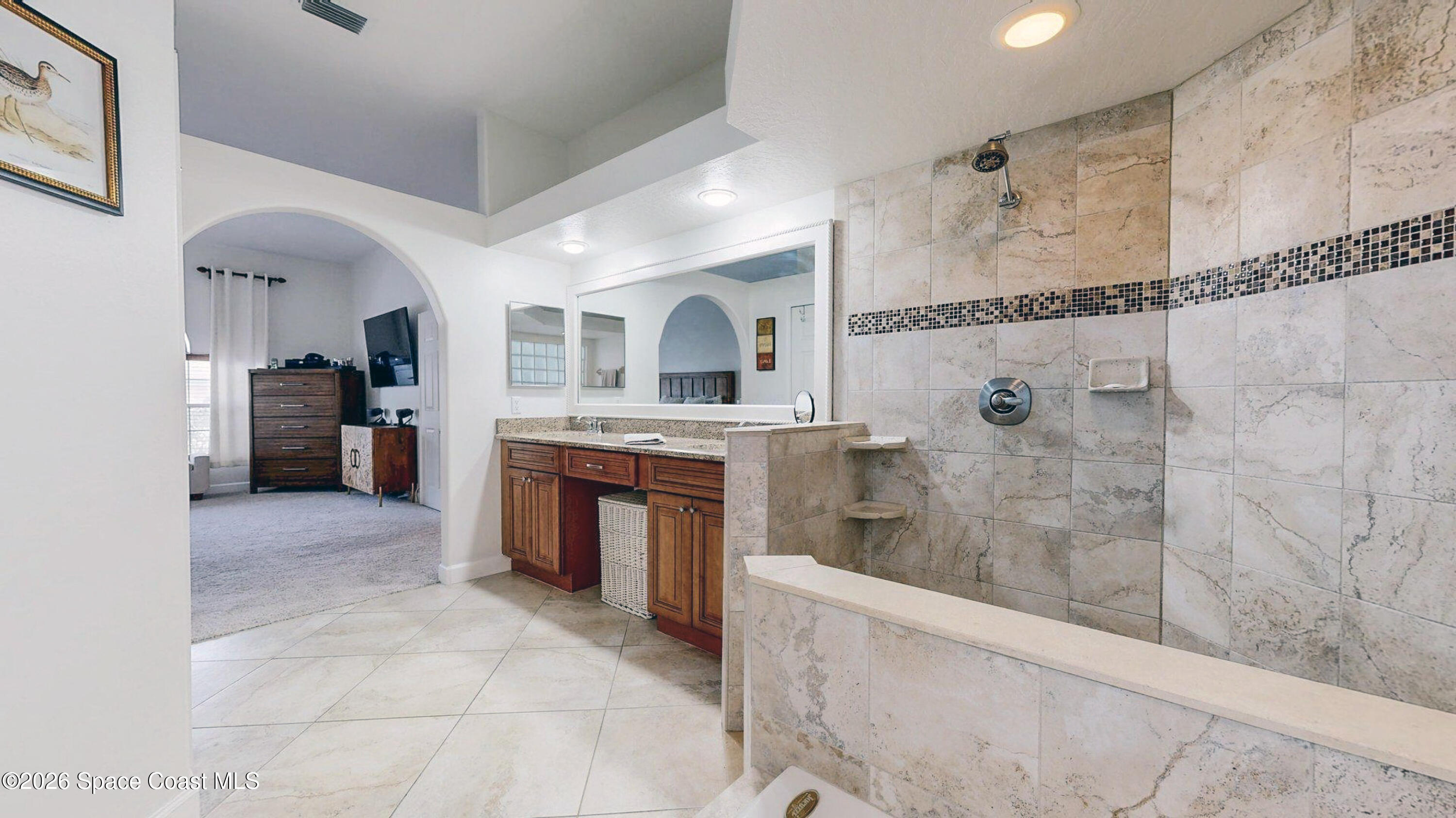 786 Conestee Drive Melbourne, FL 32904 - Photo 15 of 38 a spacious bathroom with a granite countertop sink mirror and shower