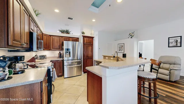 a kitchen with stainless steel appliances granite countertop a refrigerator and a stove top oven