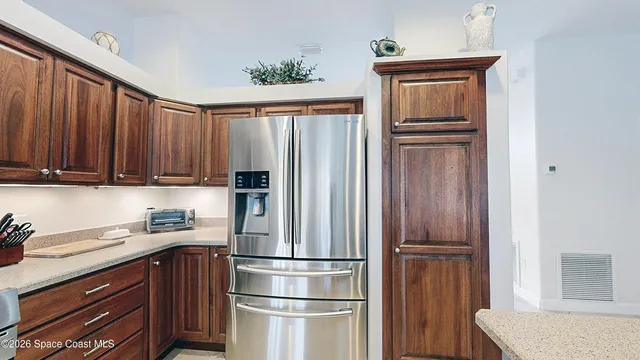 a kitchen with stainless steel appliances granite countertop a refrigerator and a sink